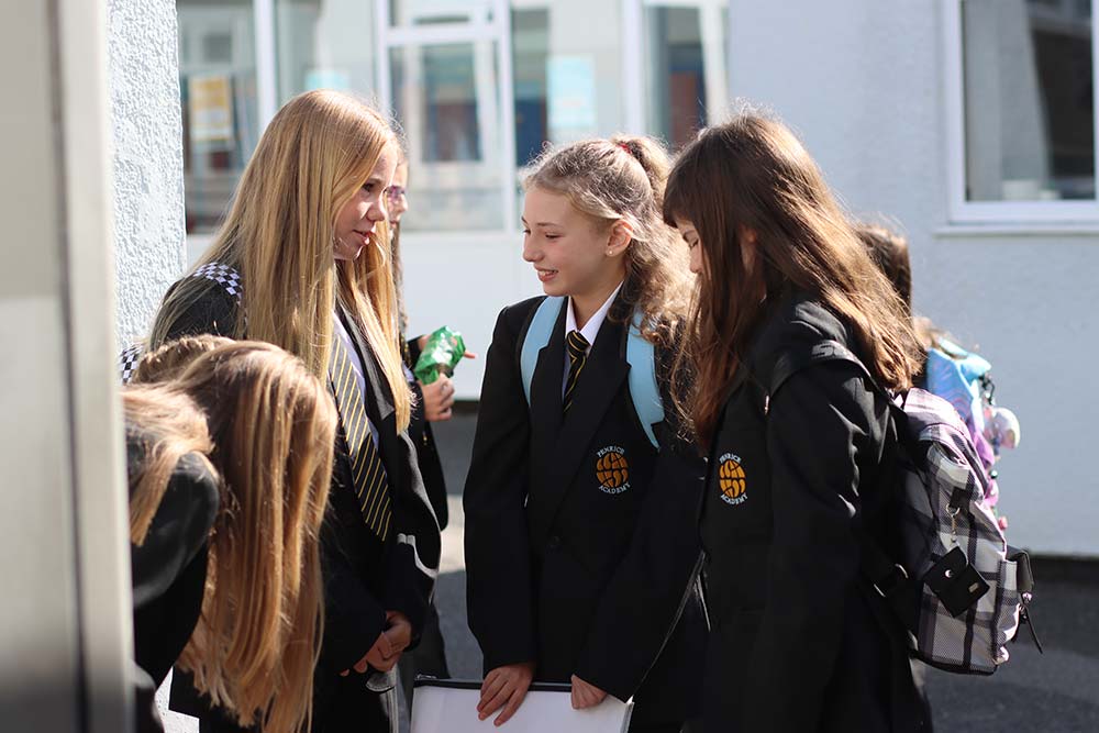 An image of three Year 7 girls talking at breaktime.